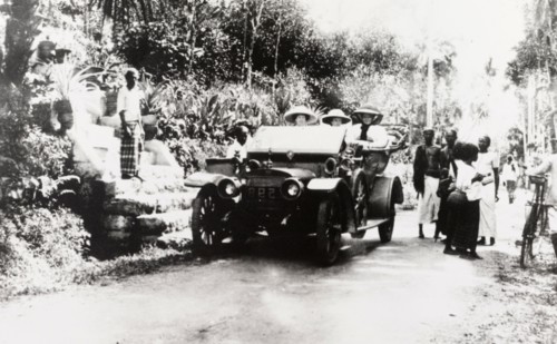 European women in convertible car, Ceylon. Three European women travel in a convertible car along a