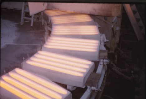 Molten copper at Nkana-Kitwe. Moulds containing molten copper rotate on a conveyor belt at a copper