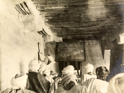 Adult students in a classroom, Kano. Adult students take notes from the blackboard during a lesson