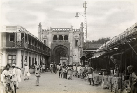 Gateway on city street, Jaora. View along a bustling city street to a large, Islamic-style arched