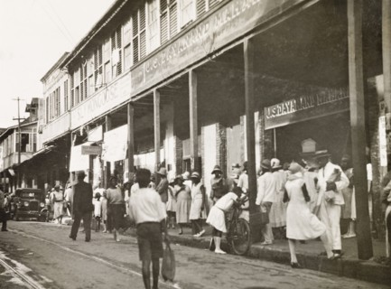 Frederick Street, Port of Spain. Crowds bustle about on Frederick Street outside a row of