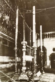 Candles in Church of the Holy Sepulchre. View of the tall, ornate candles at a shrine in the Church