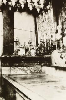 Interior of Tomb of Christ, Jerusalem. Candles line the interior of the Tomb of Christ in the