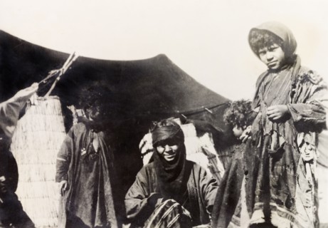 A bedouin family, Palestine. A bedouin family at the entrance to their tent. British Mandate of