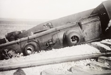 Derailment at Ras el Ain. A steam locomotive lies upturned on a railway embankment, derailed in a