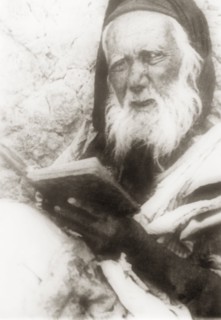Portrait of an elderly Arab man. Portrait of an elderly Arab man reading from a book. British