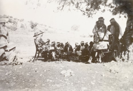 British military questioning Palestinian Arabs. British military officers sit under the shade a