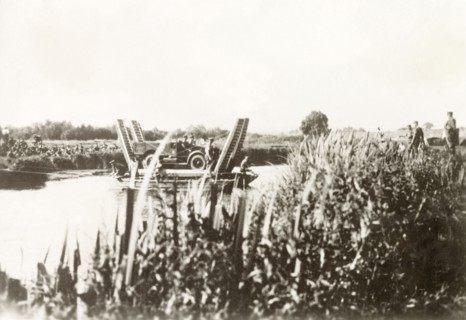 Cable ferry in Palestine. A British military vehicle is transported across a river on a cable ferry