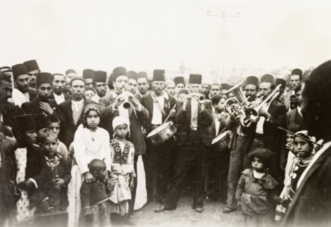 A traditional Arab wedding. Group portrait of male guests, children and musicians at a traditional