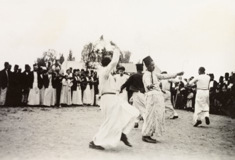 Dancing at an Arab wedding, Palestine. Several men perform a traditional dance at an Arab wedding,