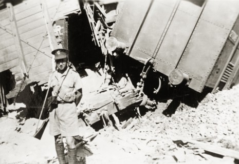 Guarding a derailment on the Kantara line. A British soldier guards the wreckage of a train on the