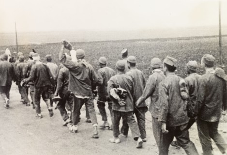 Convicts on way to work, Palestine. A chained group of Arab convicts walk along a road on their way