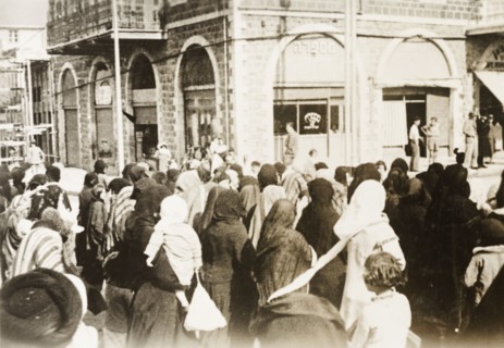 Funeral procession in Tiberias. Crowds of people take to the streets to join a funeral procession.