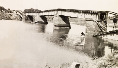 A bridge damaged by earthquake, Bihar. A collapsed railway bridge spans a river, damaged by an