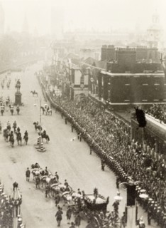 King George VI's coronation procession. Crowds of spectators line Whitehall to watch the coronation