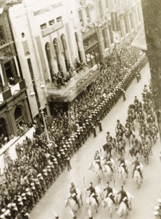 King George VI's coronation procession. Crowds of spectators line Whitehall to watch the coronation