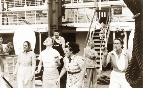Egg and spoon race aboard the Otranto. Four women compete in an egg and spoon race, holding the