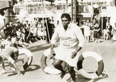 Obstacle course aboard the Otranto. Two men clamber through lifebelts as they compete in an