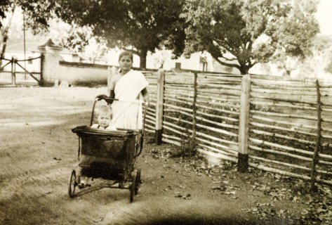 Indian ayah taking her charge for a walk. An Indian ayah (nursemaid) pushes British toddler Nell