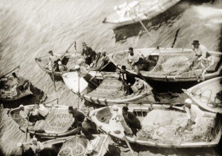 Rug vendors, Port Said. Egyptian rug vendors vie for trade in canoes at Port Said harbour. Port