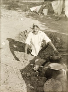 Cooking food at a Methodist camp site. A Methodist evangelist called Markappa cooks food over a