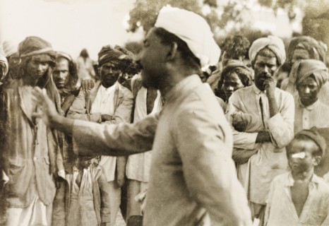 Evangelist preaching to villagers. Methodist evangelist T.B. William preaches to a gathered crowd