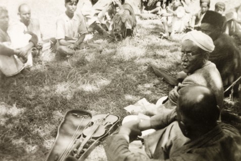 Evangelist preaching to plantation workers. A Methodist evangelist called D. Anniah sits in a