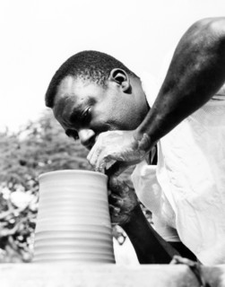 An Antiguan potter. An Antiguan potter skilfully turns a clay pot on a revolving wheel. Antigua,