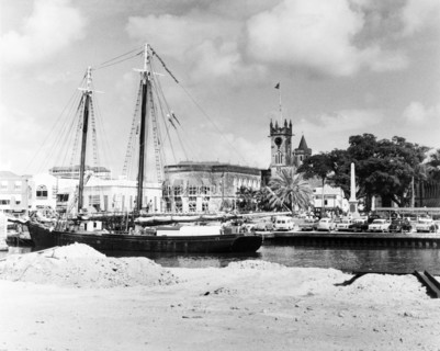 A ketch in the Careenage at Bridgetown. A ketch (twin-masted sail boat) sits at anchor in the