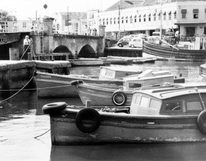 The Careenage in Bridgetown. A number of small motor boats are moored along the Careenage.