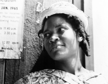 Portrait of a Grenadian woman. Portrait of a young Grenadian woman, dressed smartly in a patterned