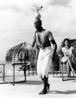 A limbo dancer in Grenada. A Grenadian man balances a vase of flowers on his head as he performs a