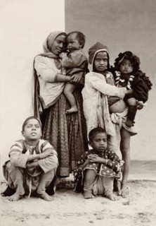 Child beggars, India. Portrait of a group of six children, including two infants, begging on the