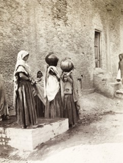 Women collecting water, Agra. A group of young Indian women collect water from a communal pump in