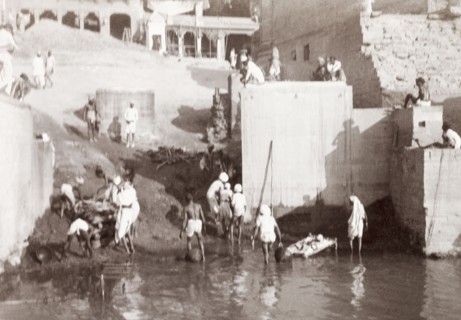 A cremation ghat in Benares. Mourning Hindus prepare to perform a cremation at a ghat (stepped