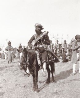 Musician at Coronation Durbar, 1903. A mounted chief from Haripur State plays a traditional Indian
