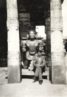 British Reverend visiting Chennakesava Temple. Reverend Norman Sargant poses beside a sculpture of