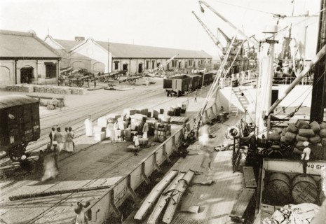 A cargo of Italian war supplies at Suez. Italian war supplies are loaded onto a ship, ready to be