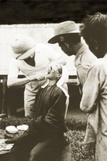 Dental treatment at Keningau Health Centre. A woman recieves dental treatment from a trainee at