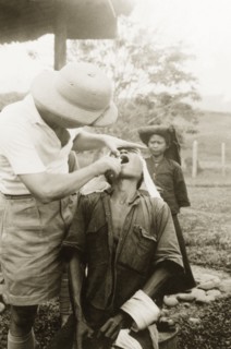 Dental treatment at Keningau Health Centre. A man receives dental treatment from a British medical