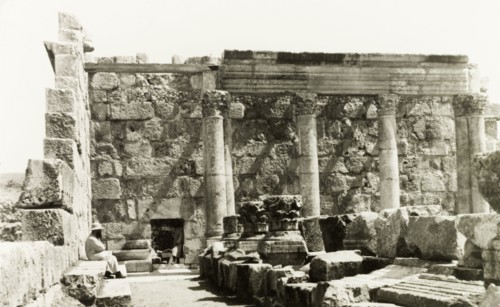 The 'White Synagogue' at Capernaum. Fragments of carved stone capitals and columns lie within the