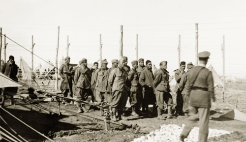 Palestinian soldiers in a fenced compound. A group of Palestinian soldiers, possibly detainees,