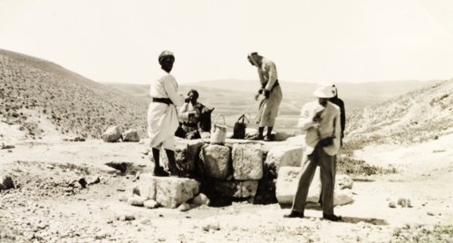 Drawing water from a desert well. A party of travellers draws water from a desert well in