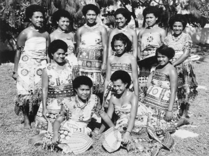 Fijian women wearing 'masi' cloth. A group of Fijian women pose for a portrait, wearing printed