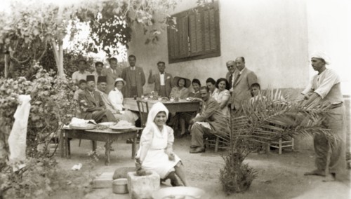 Lunch at Beit Hanoun. A group of friends pose for a portrait as they enjoy lunch together outdoors.