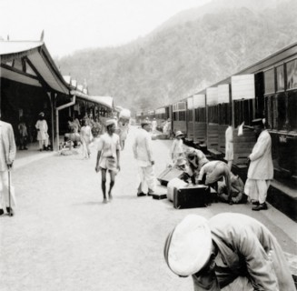 Unloading luggage at Kathgodam railway station. Indian porters help European passengers to unload