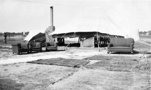 Drying out after a storm. Grass mats and furniture sit outside a large marquee, drying in the sun