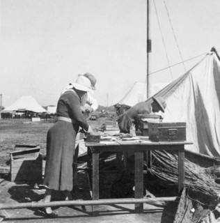 Salvaging books after a storm. A European couple salvage books and papers after a heavy storm at