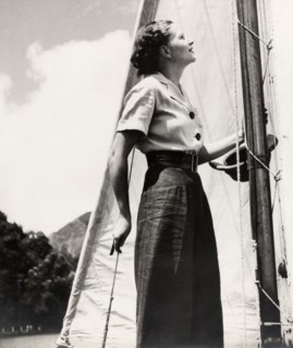 Yachting on Naini Tal Lake. A young woman stands on the deck of a yacht on Naini Tal Lake, dressed