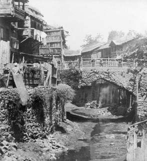 The Mar Canal in Srinigar. A trickle of water runs past ramshackle buildings and beneath a small